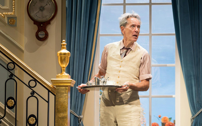Actor holding a tray during HAY FEVER performance, Westend theater scene.