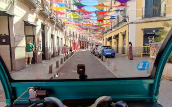 Colorful street view from a tuk-tuk during a private 2-hour tour in Madrid with a local guide.