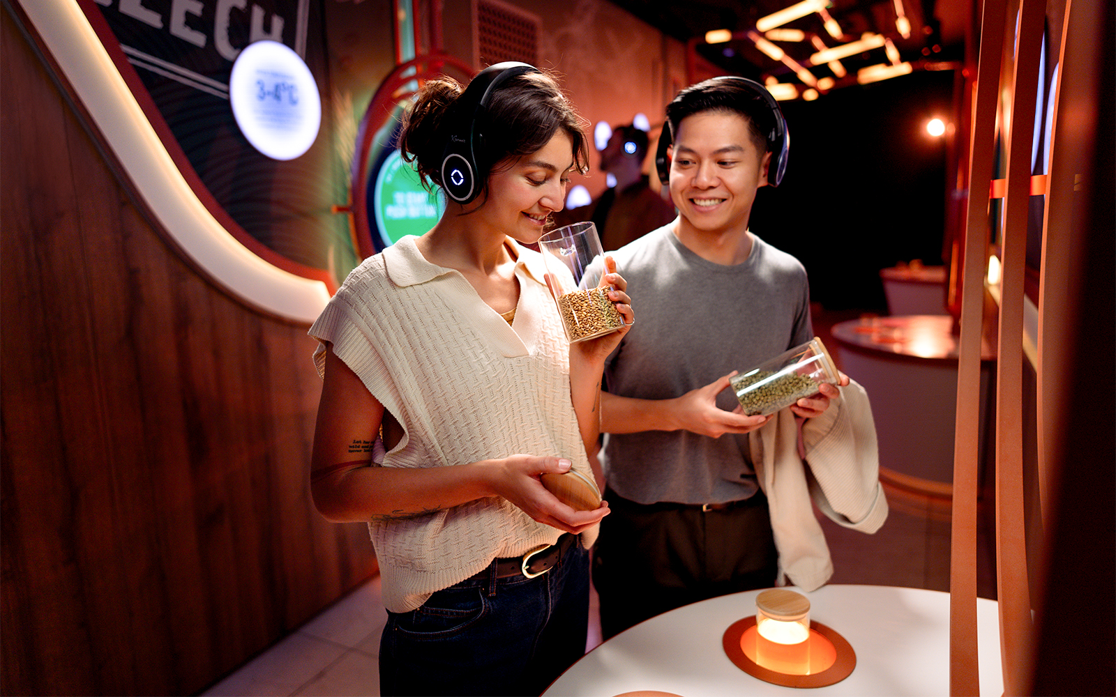 Visitors enjoying the Prague Pilsner Urquell Experience, examining beer ingredients.