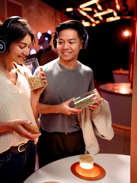 Visitors enjoying the Prague Pilsner Urquell Experience, examining beer ingredients.