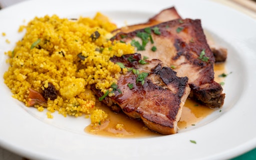 Grilled meat with couscous served on a plate during the Guadix & Tabernas Desert tour.