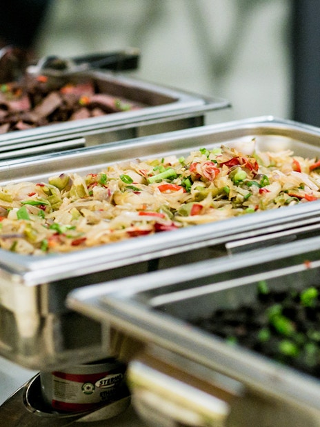 Buffet trays with assorted dishes for tour lunch.