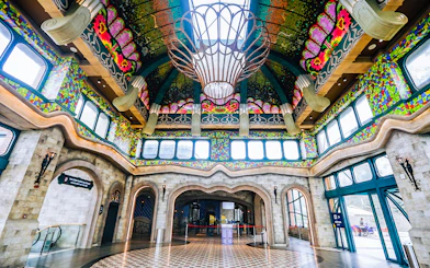 Colorful interior of Sun World Ba Den Mountain entrance hall with ornate ceiling and stained glass windows.