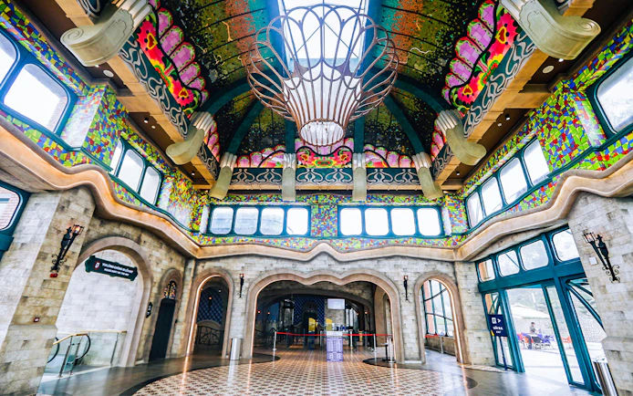 Colorful interior of Sun World Ba Den Mountain entrance hall with ornate ceiling and stained glass windows.