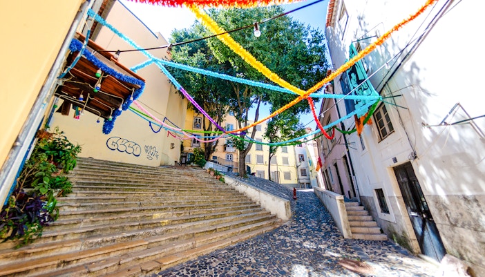 Colorful streamers over steps in Mouraria, Lisbon, Portugal.
