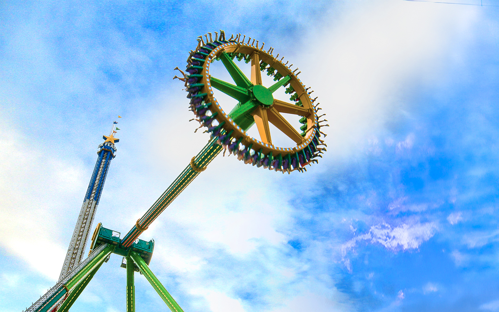 THE RIDDLER'S™ Revenge ride at Six Flags Over Texas against a blue sky.