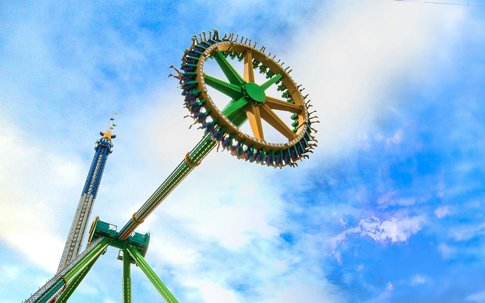 THE RIDDLER'S™ Revenge ride at Six Flags Over Texas against a blue sky.