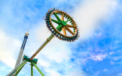 THE RIDDLER'S™ Revenge ride at Six Flags Over Texas against a blue sky.
