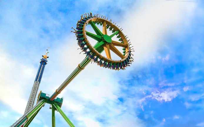 THE RIDDLER'S™ Revenge ride at Six Flags Over Texas against a blue sky.