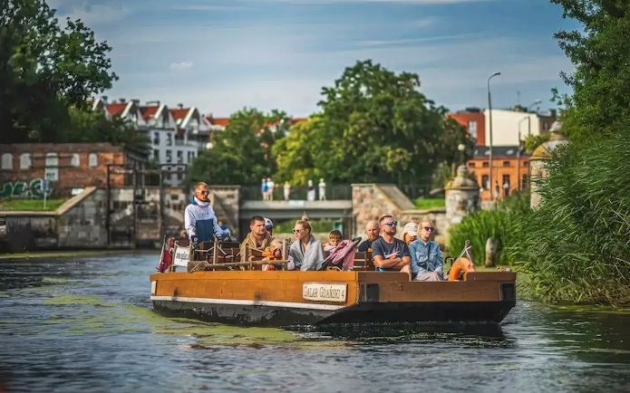 Gdansk historical Galar boat cruise with passengers on a scenic river.