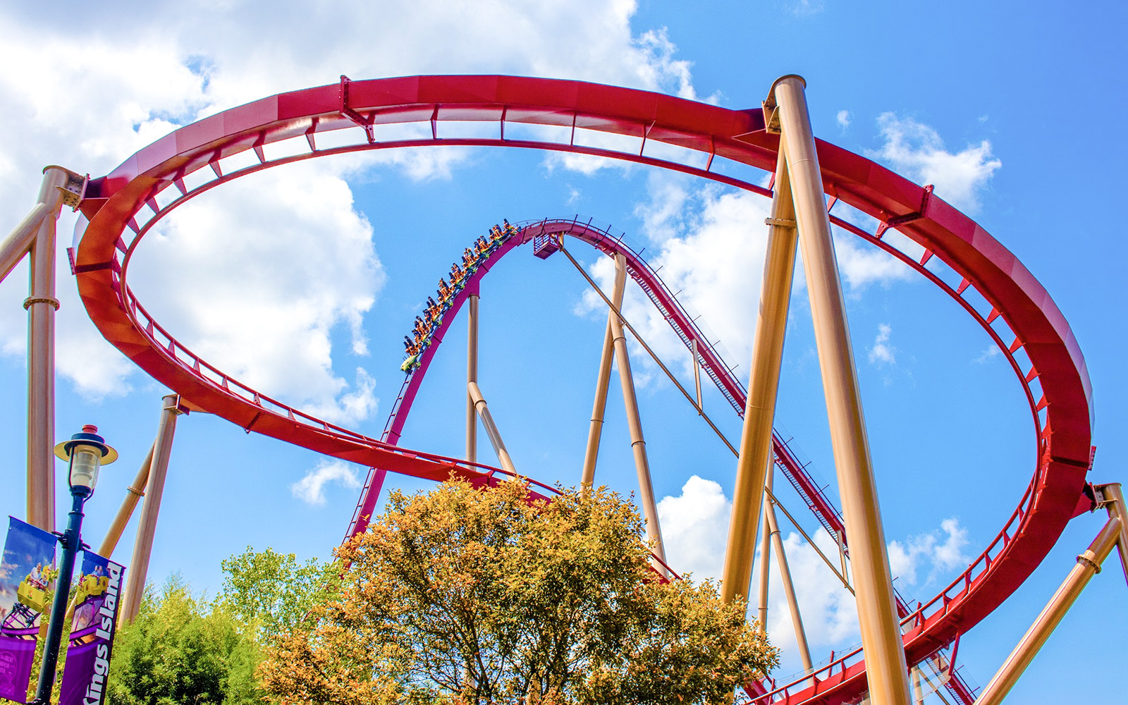 Roller coaster loop at Diamondback, Kings Island against blue sky.