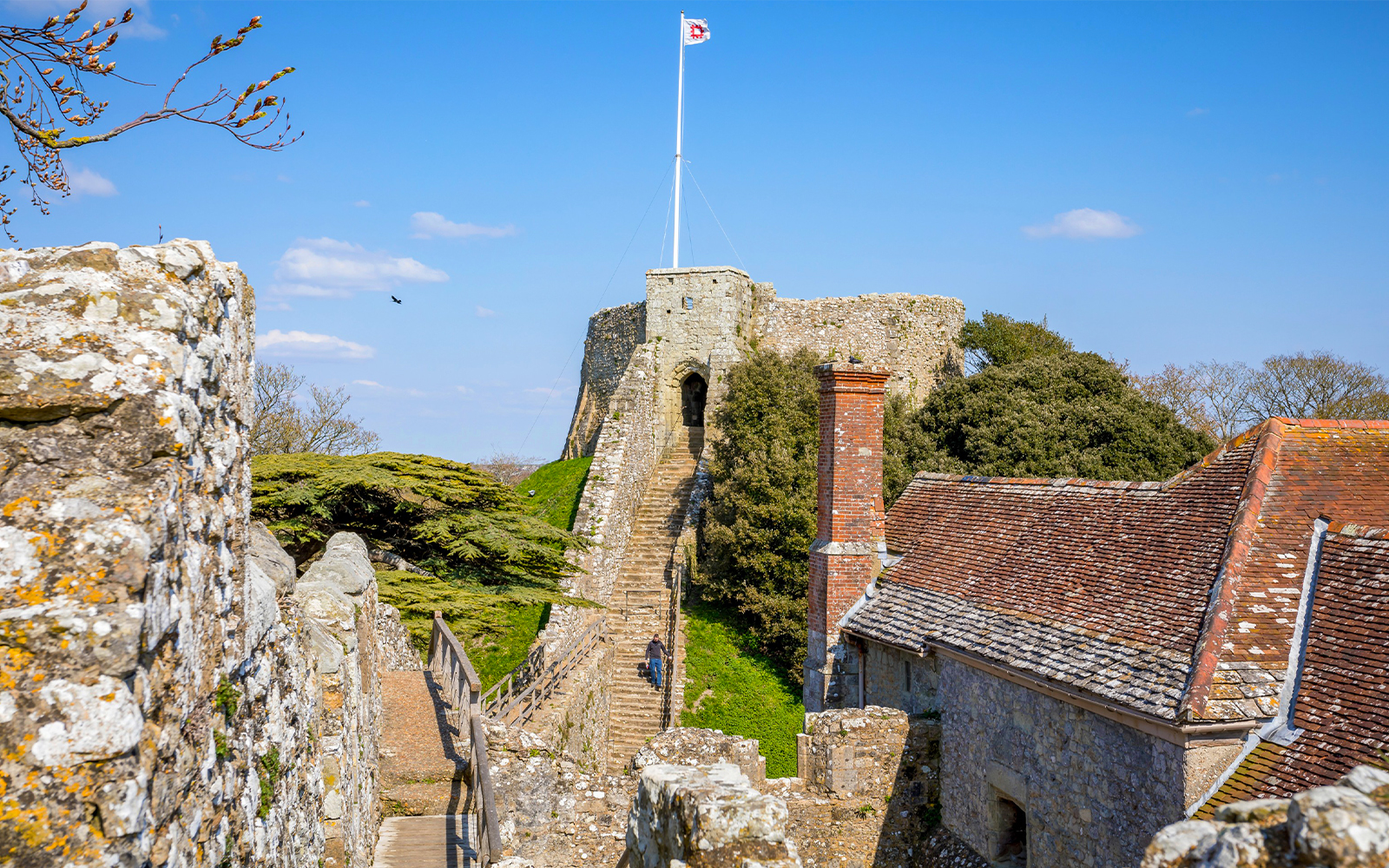 Carisbrooke Castle stone walls and gatehouse on a sunny day, Isle of Wight, England.