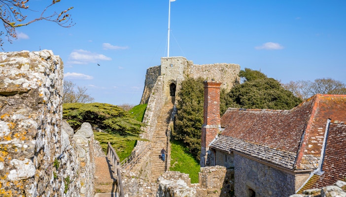 Carisbrooke Castle stone walls and gatehouse on a sunny day, Isle of Wight, England.