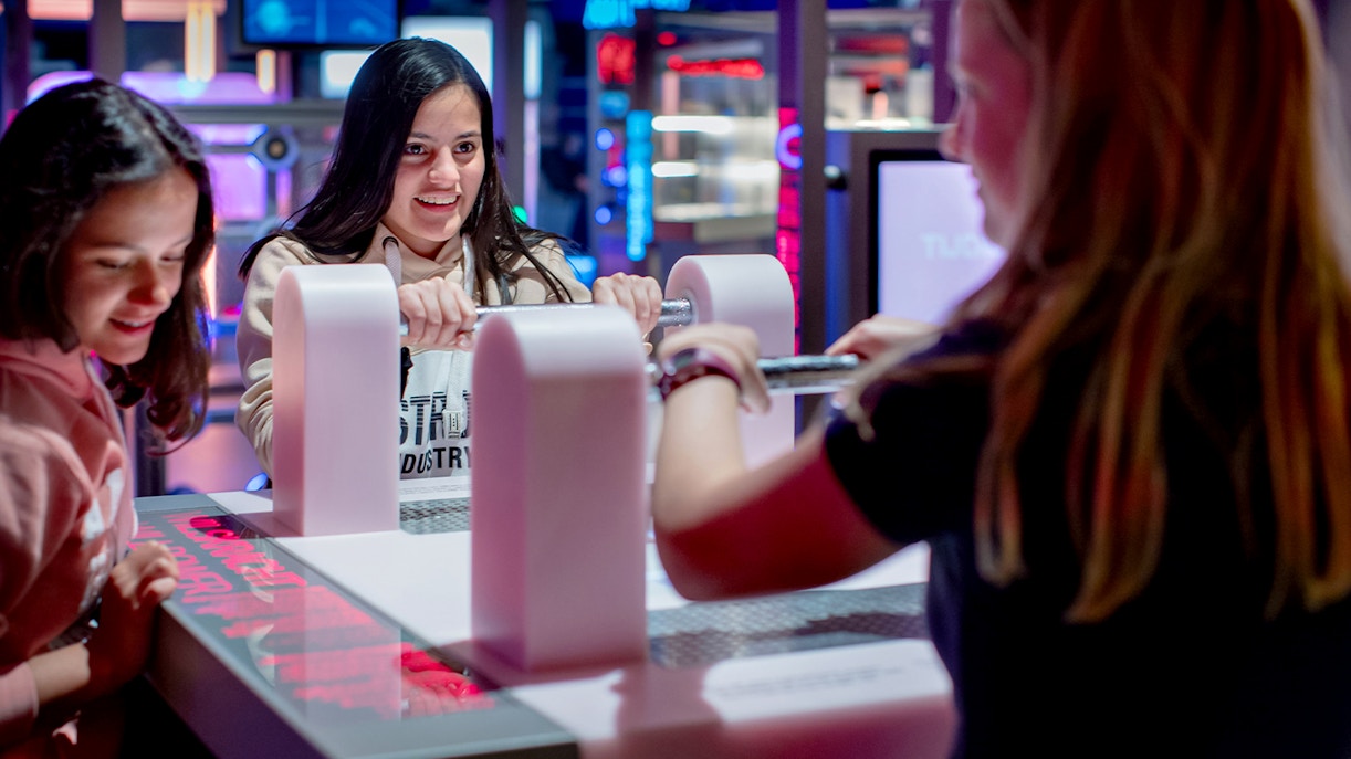 Visitors engaging with interactive exhibit at NEMO Science Museum.