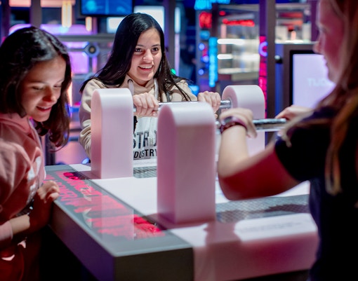 Visitors engaging with interactive exhibit at NEMO Science Museum.