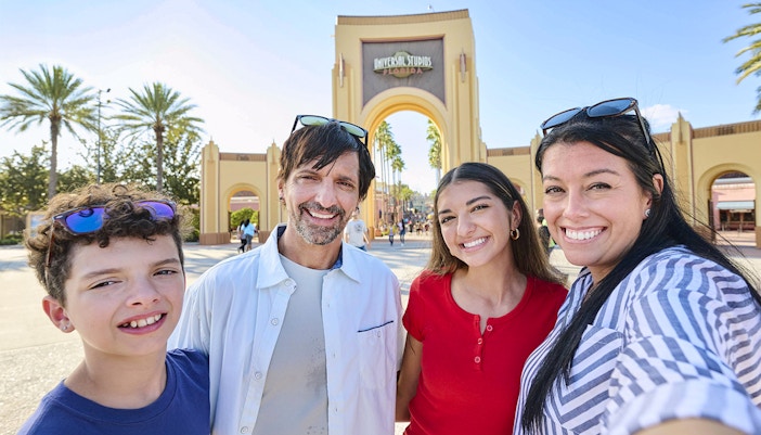 Guests in front of the Universal Studios Florida arch at the Universal Studios Resort in Orlando