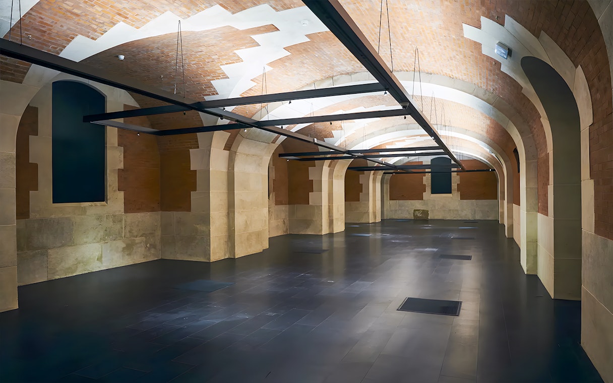 Palais Galliera interior with arched brick ceilings and stone walls in Paris.