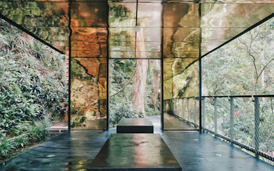 Viewing platform with reflective walls surrounded by lush greenery at Habitat Penang Hill.