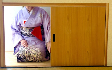 Woman in kimono participating in a traditional tea ceremony in Kyoto.