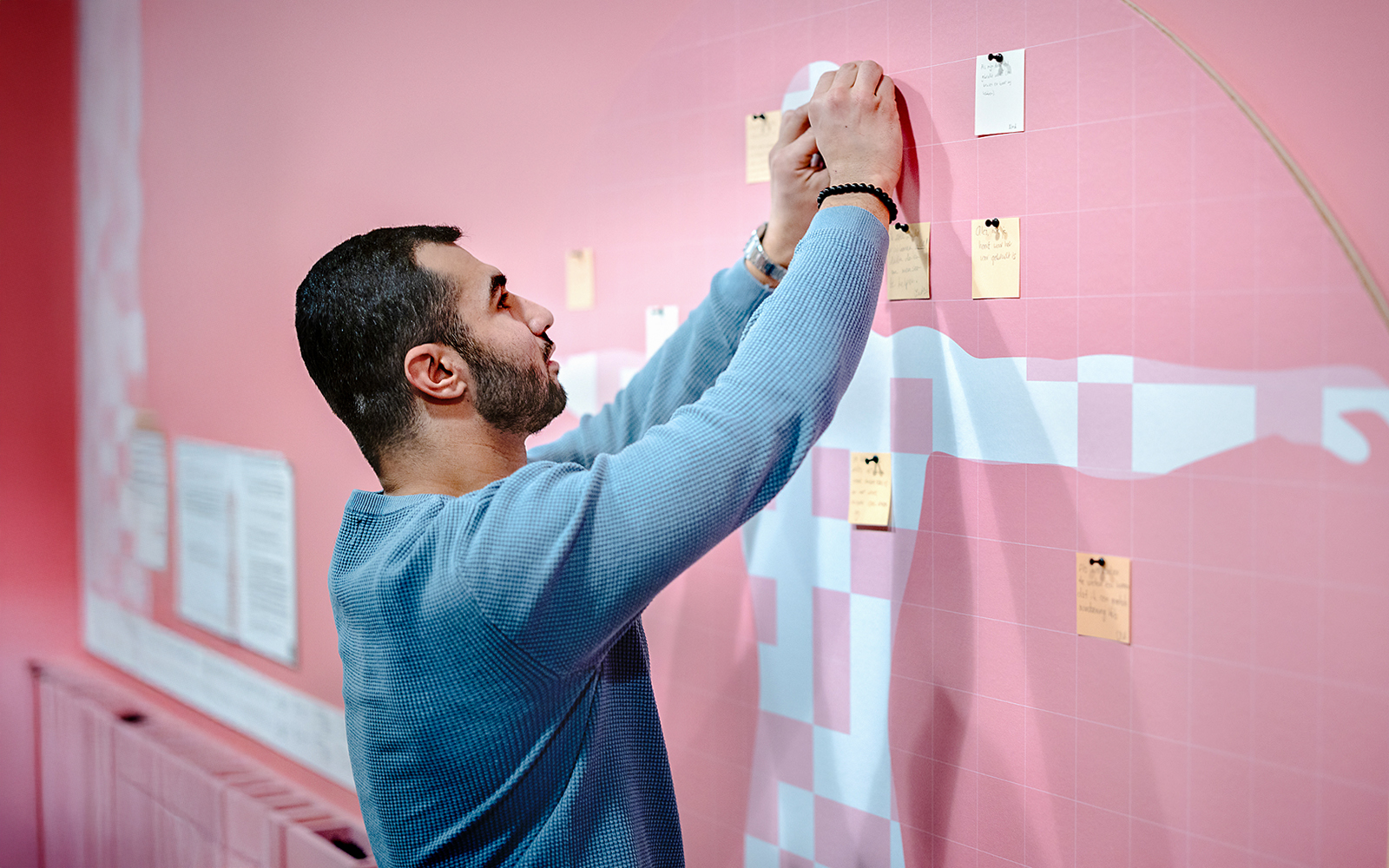 Guest placing notes on an interactive exhibit at NEMO Science Museum.