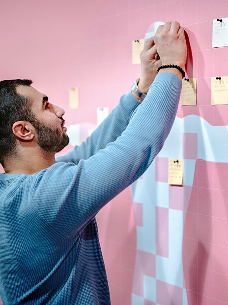 Guest placing notes on an interactive exhibit at NEMO Science Museum.