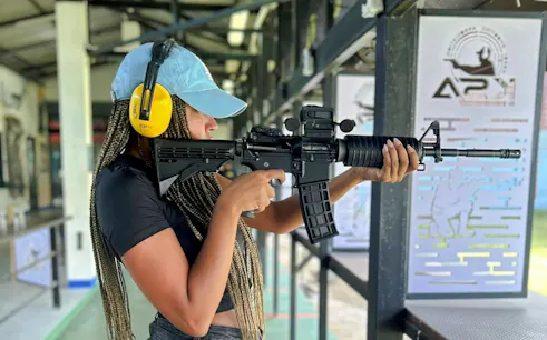 Participant aiming rifle at shooting range during Krabi ATV Adventure & BB Gun Shooting Experience.