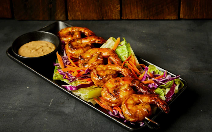 Grilled shrimp skewers with salad and dipping sauce, Cairns Aquarium Night Tour dinner option.
