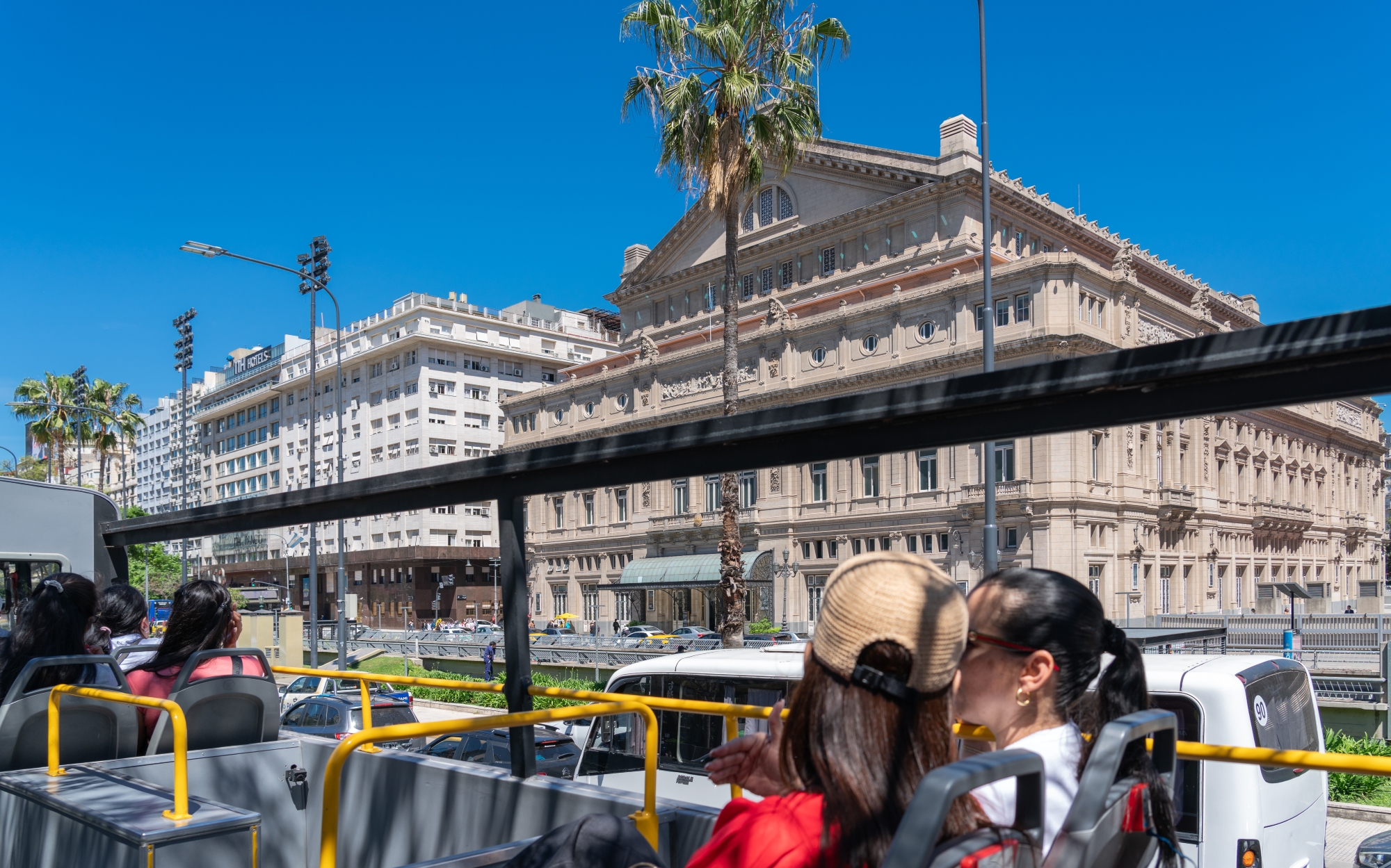 Tourists on Buenos Aires Hop-on Hop-off Bus viewing Teatro Colón.