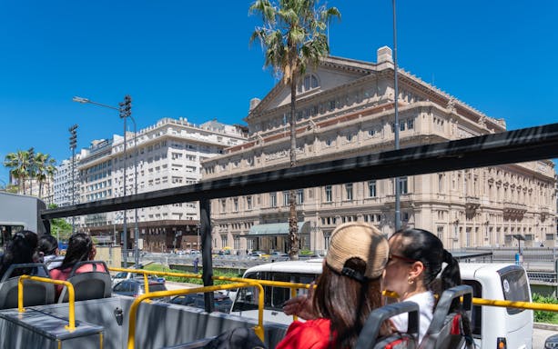 Tourists on Buenos Aires Hop-on Hop-off Bus viewing Teatro Colón.