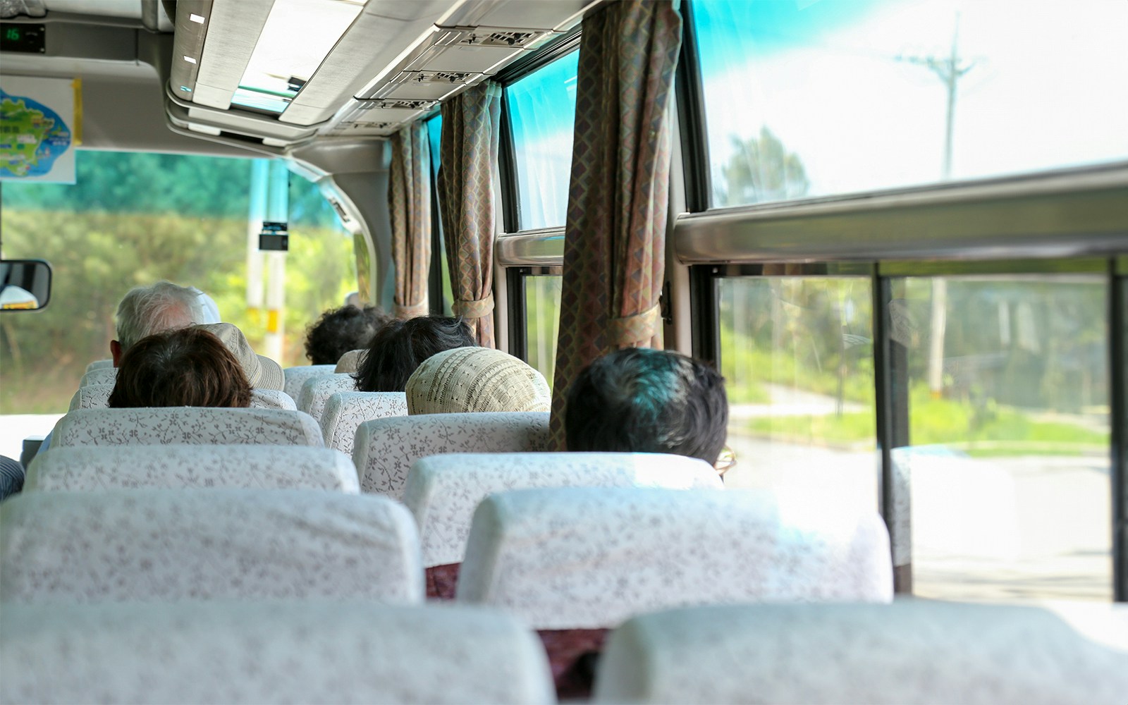 Passengers seated inside an AC coach bus for Nara and Kyoto One-Day Tour.