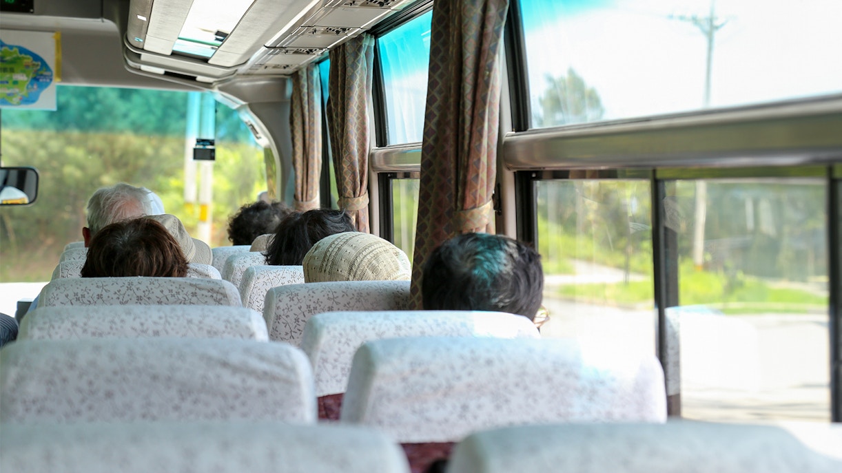Passengers seated inside an AC coach bus for Nara and Kyoto One-Day Tour.
