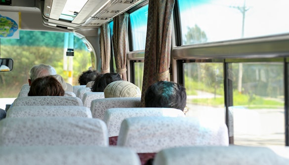 Passengers seated inside an AC coach bus for Nara and Kyoto One-Day Tour.