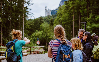 Tour group with guide near Neuschwanstein Castle in Germany.