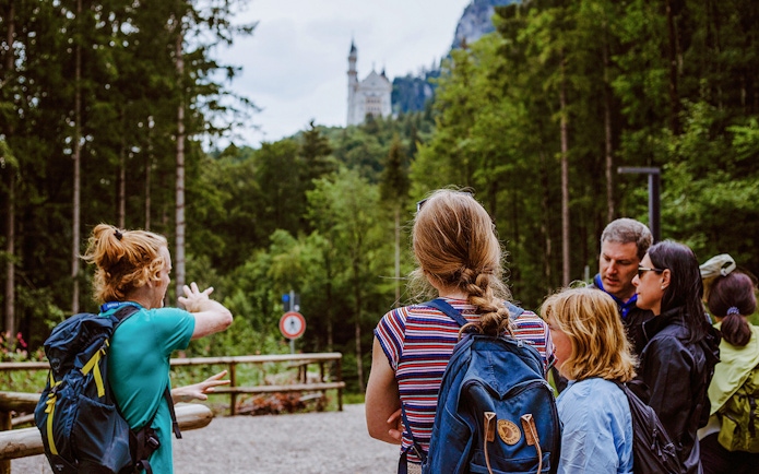 Tour group with guide near Neuschwanstein Castle in Germany.