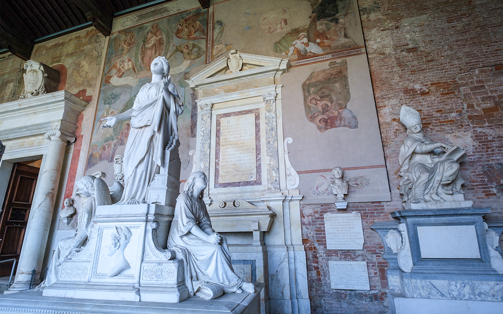 Pisa Camposanto tombs with ancient sculptures and intricate carvings in Italy.