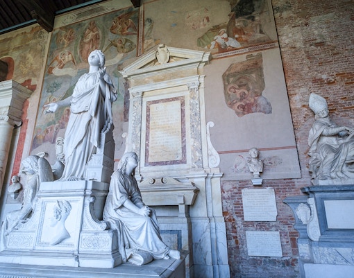 Pisa Camposanto tombs with ancient sculptures and intricate carvings in Italy.