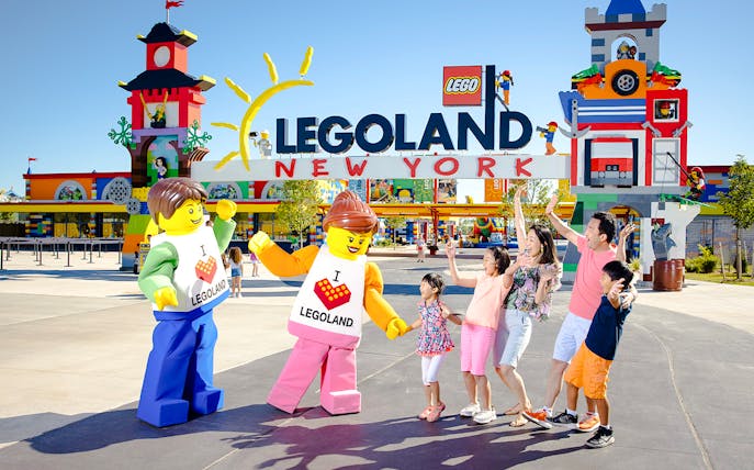 Guests interacting with Lego characters at Legoland New York entrance.