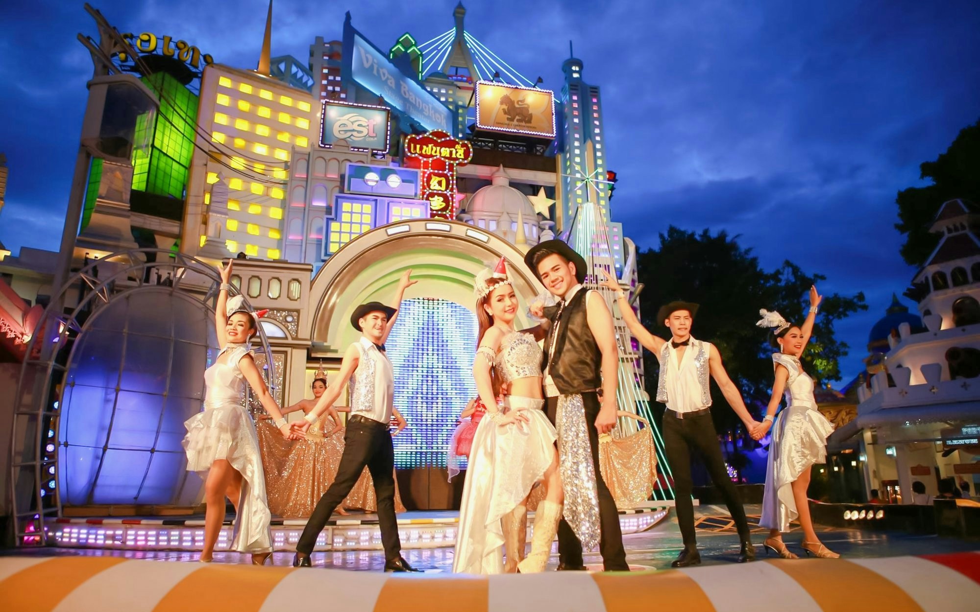 Performers in vibrant costumes on stage at Festival Village in Fantasea, Phuket.