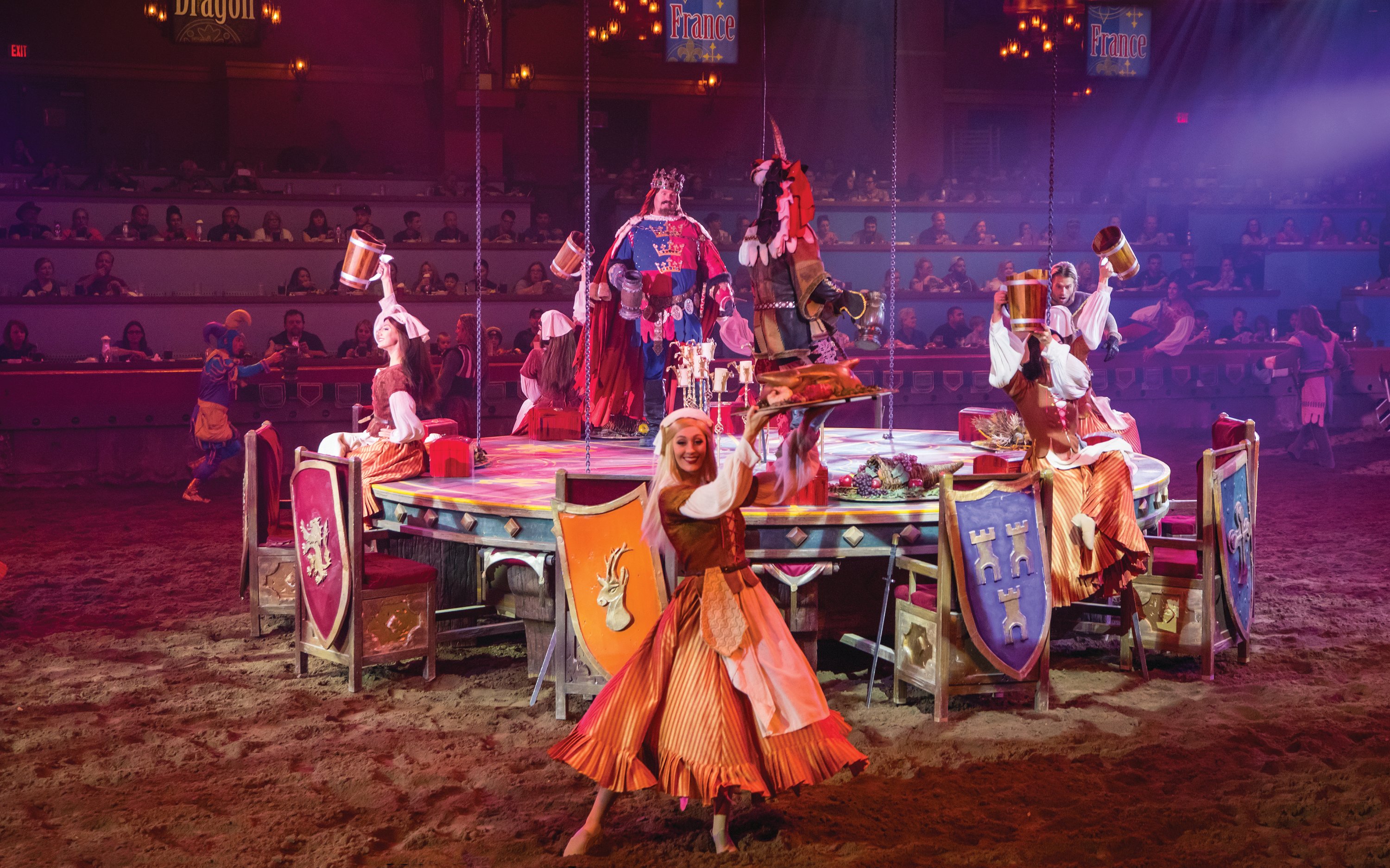 Knights and performers at Tournament of Kings show in Las Vegas arena.