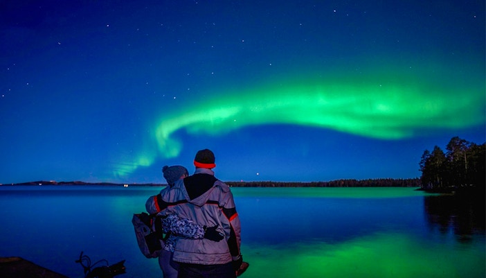 couple trying to listen to northern lights sound