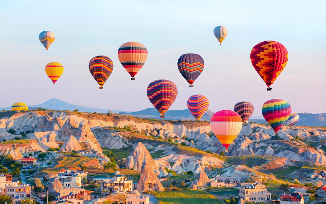 Hot air balloons over Cappadocia's unique rock formations, Turkey.