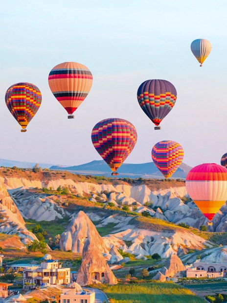 Hot air balloons over Cappadocia's unique rock formations, Turkey.
