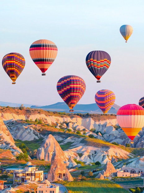 Hot air balloons over Cappadocia's unique rock formations, Turkey.