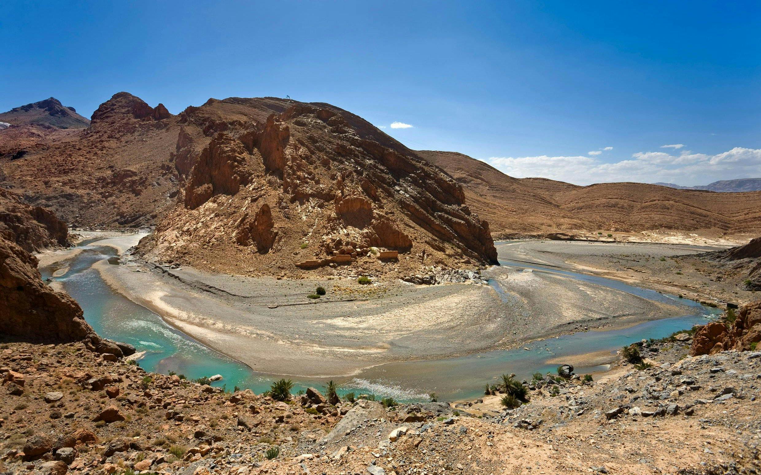 Gorges du Ziz in Morocco with winding river and rocky desert landscape.