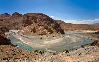 Gorges du Ziz in Morocco with winding river and rocky desert landscape.