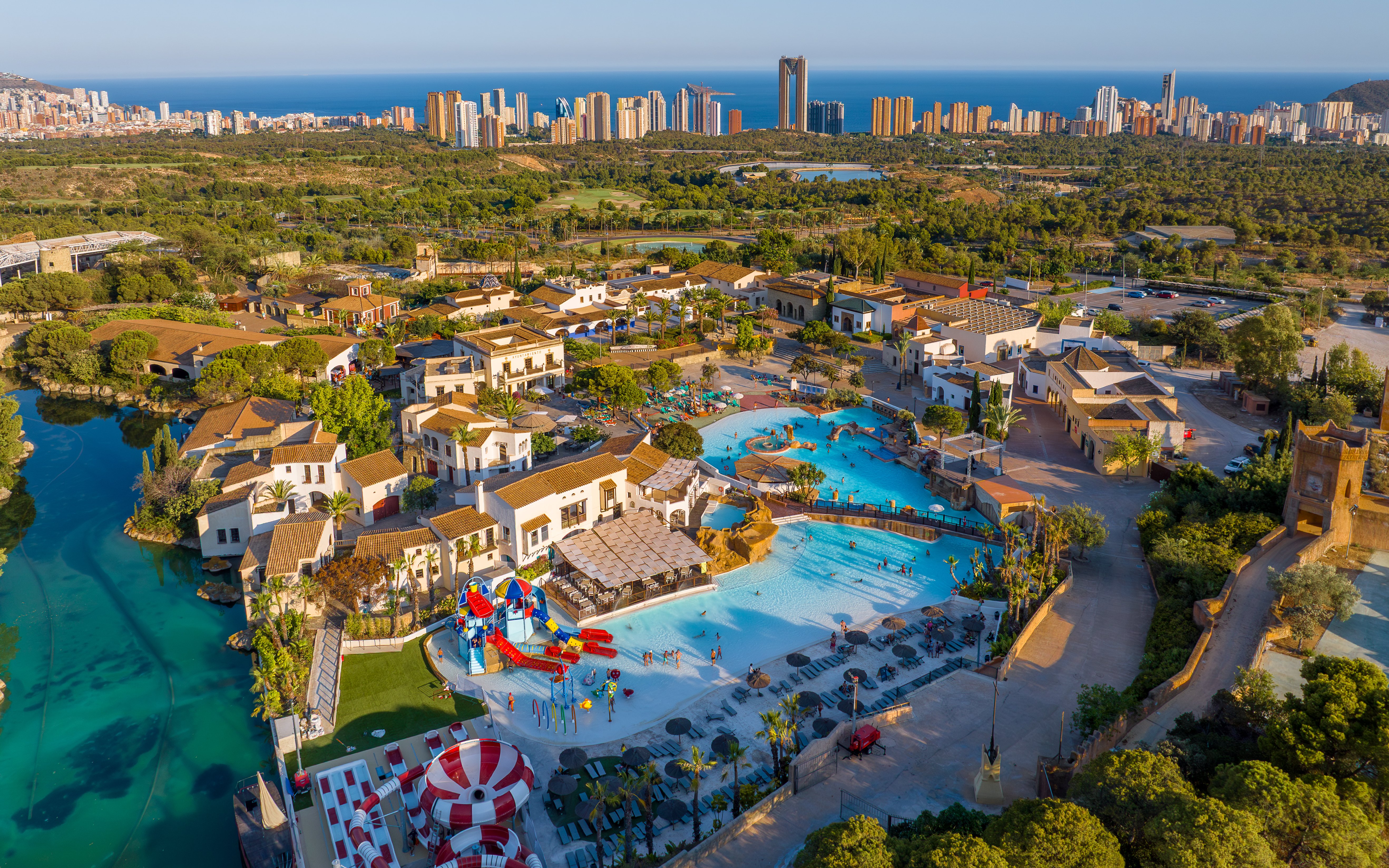 Aerial view of Terra Mitica Benidorm with pools, attractions, and surrounding landscape.