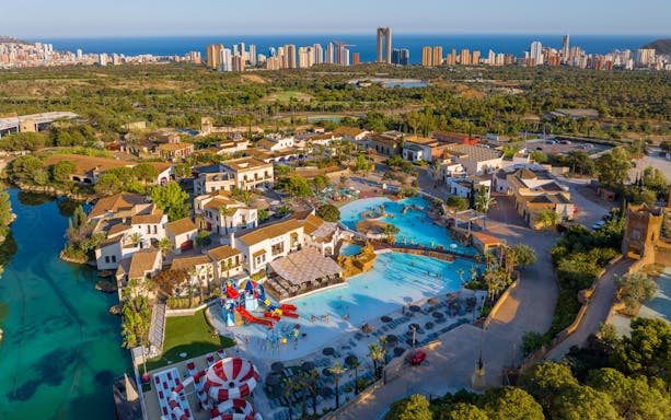 Aerial view of Terra Mitica Benidorm with pools, attractions, and surrounding landscape.
