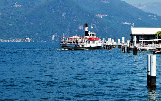 Ferry approaching dock on Lake Como during Bellagio and Varenna full-day tour.