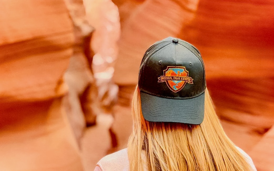 Visitor wearing a National Park Express cap in Antelope Canyon.