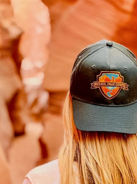 Visitor wearing a National Park Express cap in Antelope Canyon.